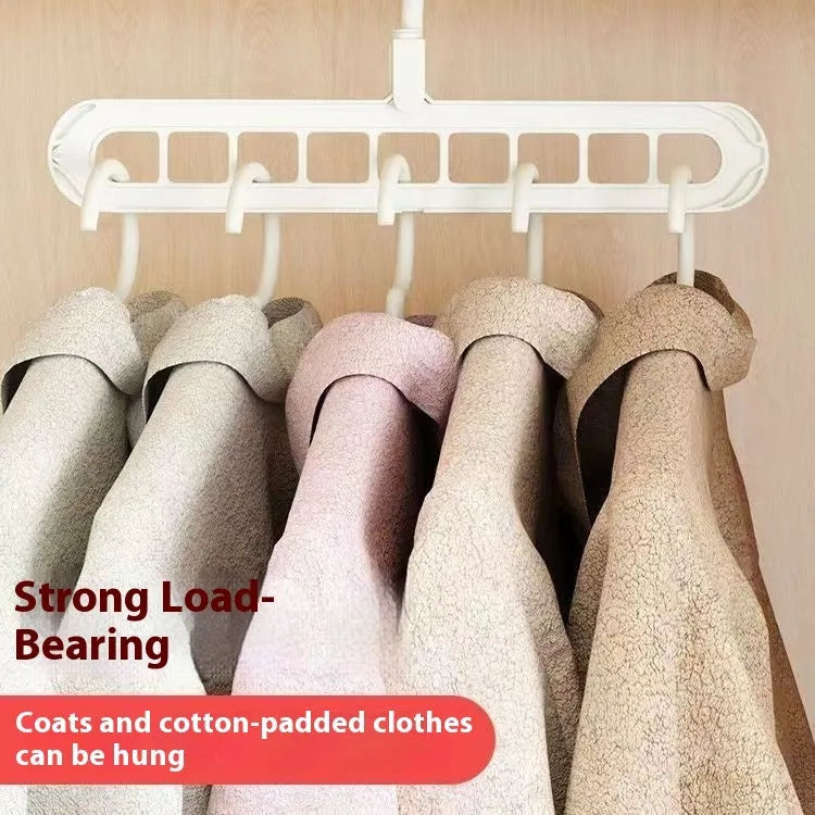 Green nine-hole plastic trouser hanger with folding design for wardrobe organisation