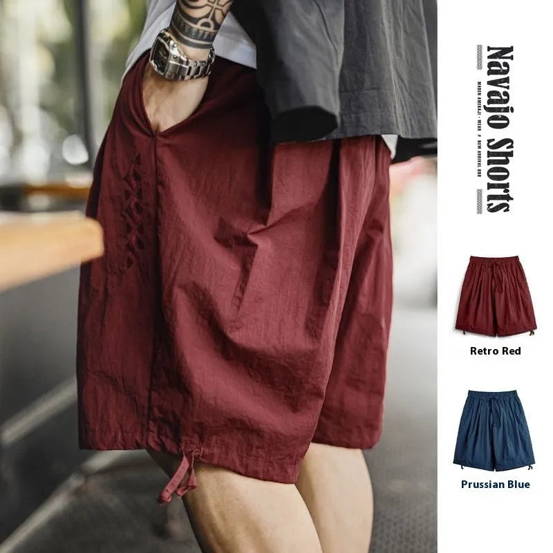 Men's Prussian blue nylon beach shorts with embroidered detail and elastic waistband