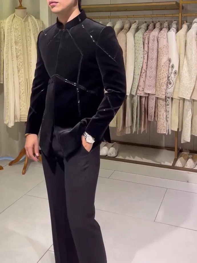 Black structured jacket with contrast geometric patchwork accents, regular fit, front view