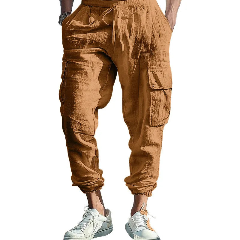 Men's loose linen trousers in Army Green with ankle ties and a multi-pocket tether detail.