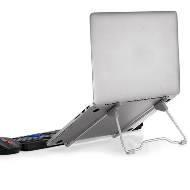 Grey aluminium alloy and plastic stand holding a mobile phone and a laptop.