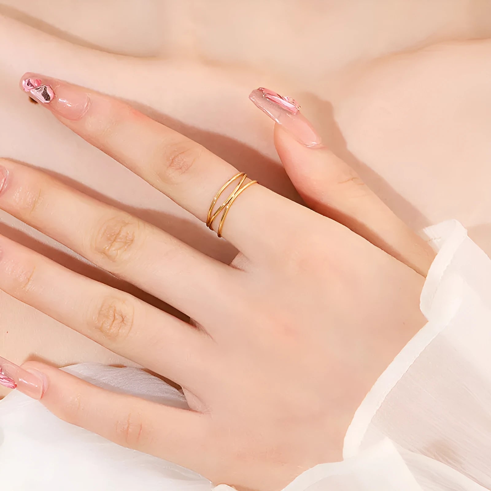 Gold titanium steel three-layer geometric line ring shown on finger, available in sizes No 5 to No 10