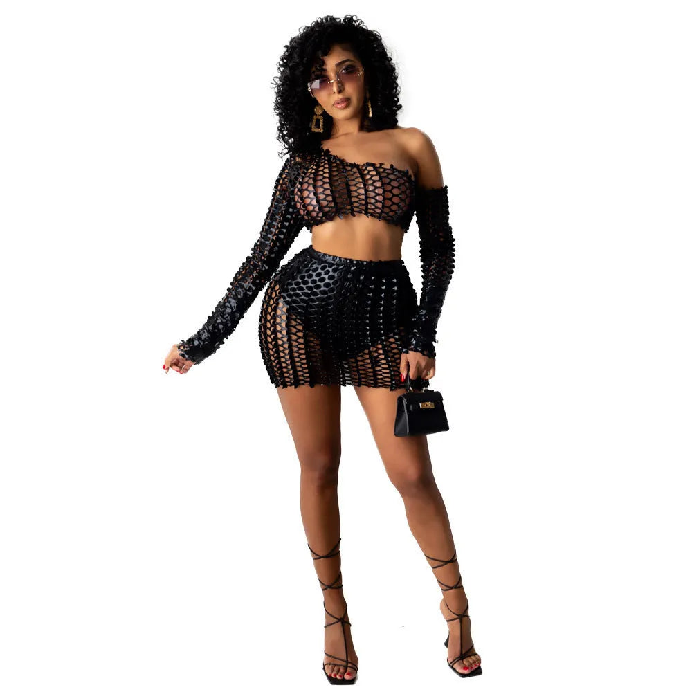 Women's black two-piece dress set with sleeveless hollow-out net top and matching short skirt.