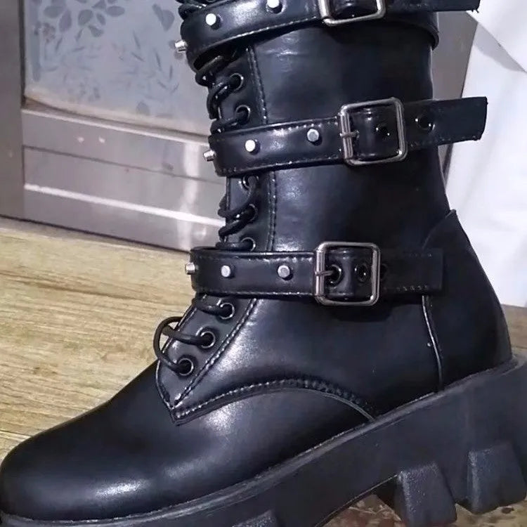 Women's black mid-calf buckle boots with side zipper and round toe on wooden floor