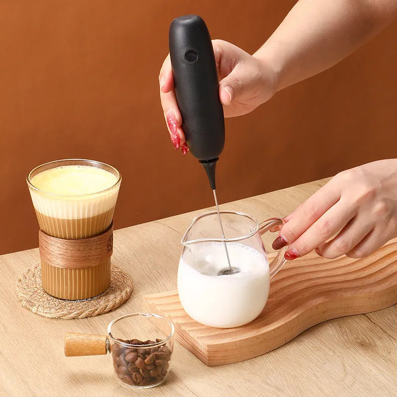Black and white handheld electric milk frother blender for coffee beverages