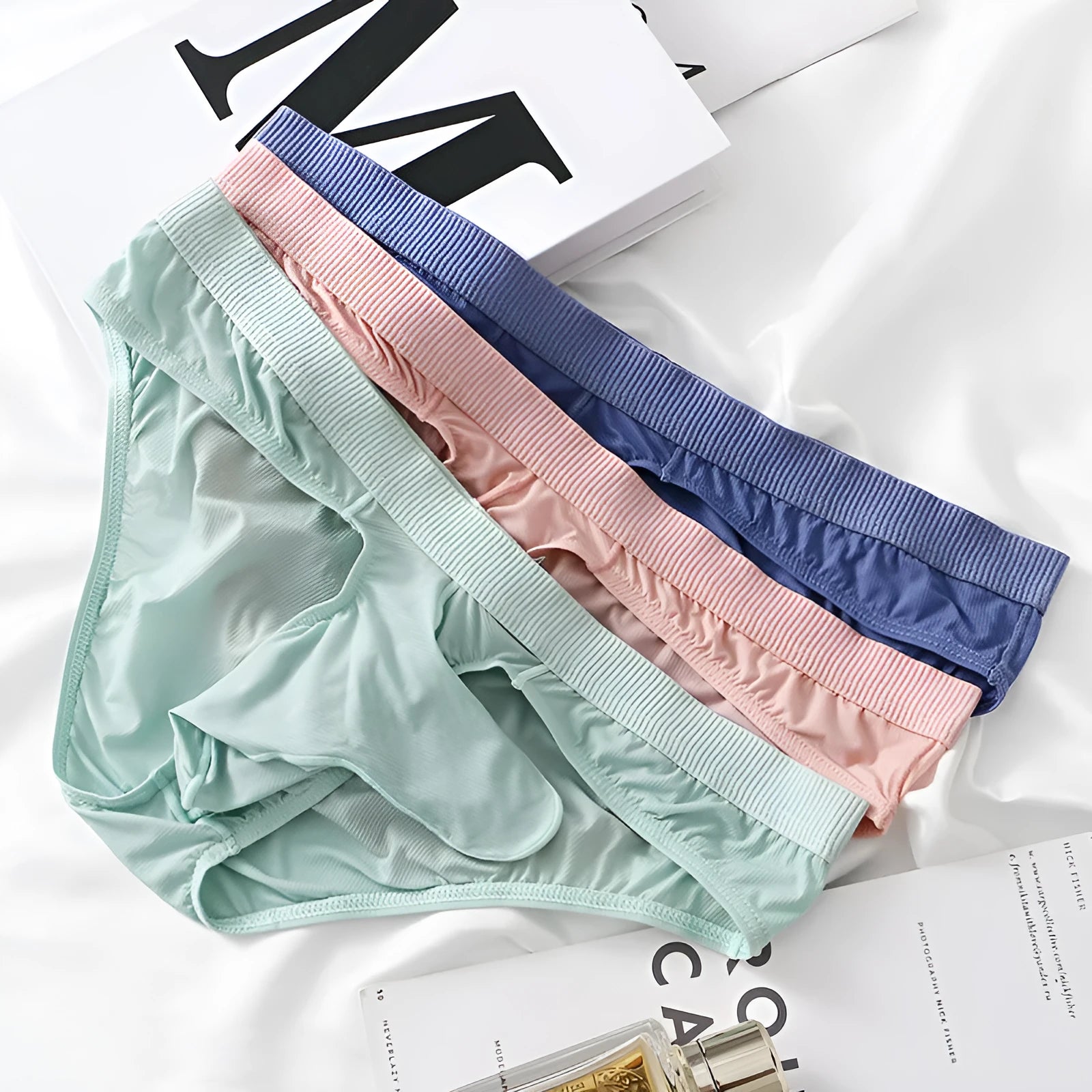 Men's low waist briefs underwear in Ice Silk fabric showing colour options: black, grey, light green, pink, purplish blue