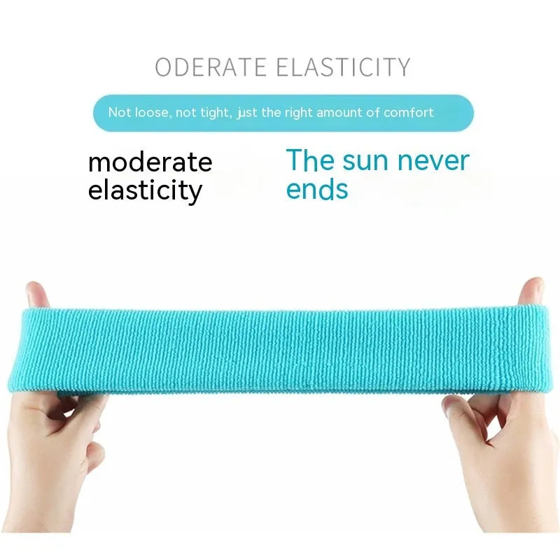Elastic solid colour sports sweatband in black, shown on a white background.