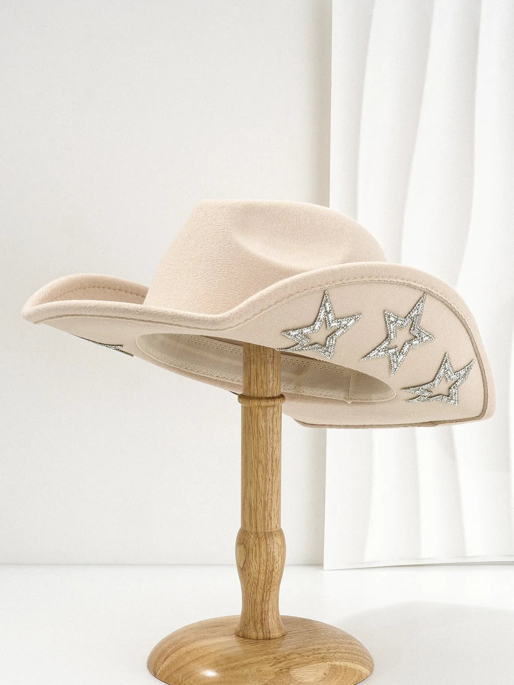 Denim top hat made from woolen felt with a conical crown and hexagonal star decoration.