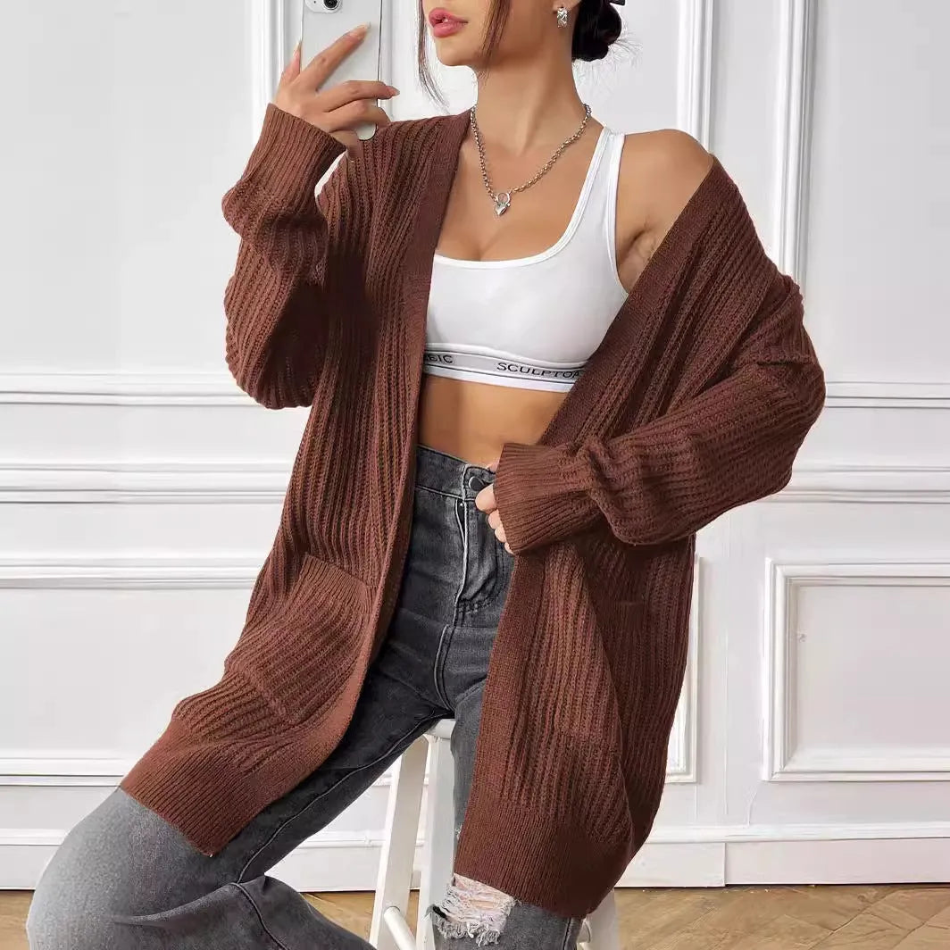 Women's double pocket cardigan in acrylic fabric showing loose fit and 65cm length