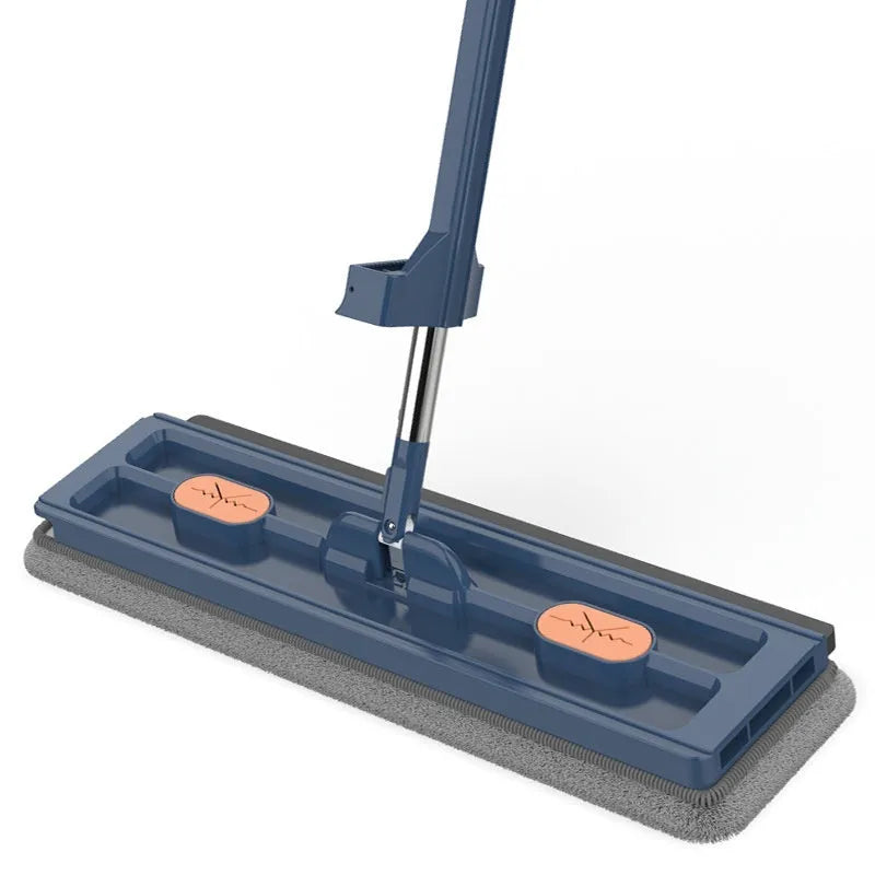 Large flat mop with long stainless steel handle and blue rotating mop head on a wooden floor.