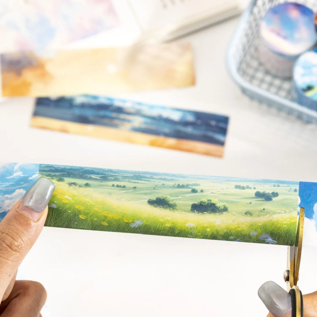Roll of Japanese paper decorative washi tape with sky theme designs, showing colourful clouds, sunny day, and twilight patterns.