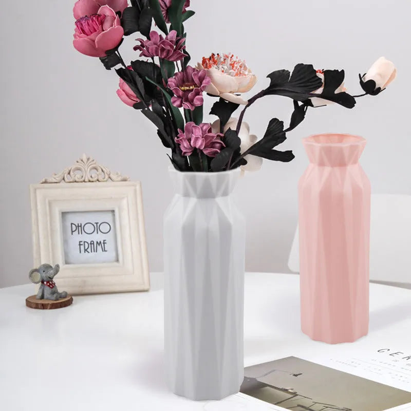 Grey melamine plastic vase with a wide 7.2cm base on a wooden table.
