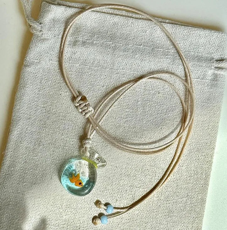 Women's joker charm pendant necklace in coloured glaze on a cotton and linen clavicle chain.