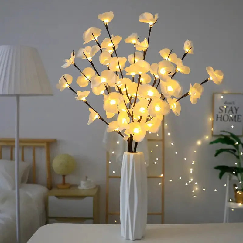 Pink LED phalaenopsis orchid branch decorative light, 65cm long with fabric blossoms.
