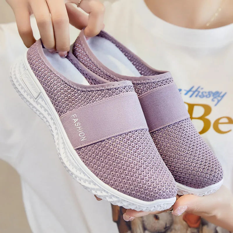 Women's casual flat shoes with mesh upper and hollow-out design in black, grey, pink, or purple.