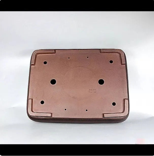 Handmade antique rectangular purple clay flower pot for plants on a tabletop.
