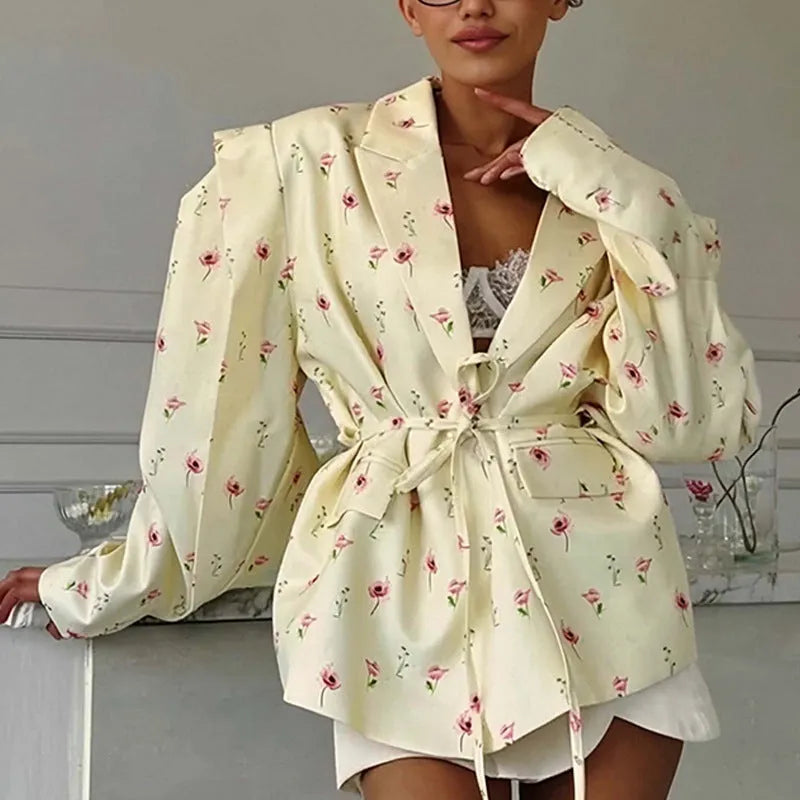 Women's apricot suit jacket with lace-up detail on the collar and a cinched waist.