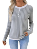 Women's black fake two-piece pullover sweater with a round neck and a button on the shoulder.