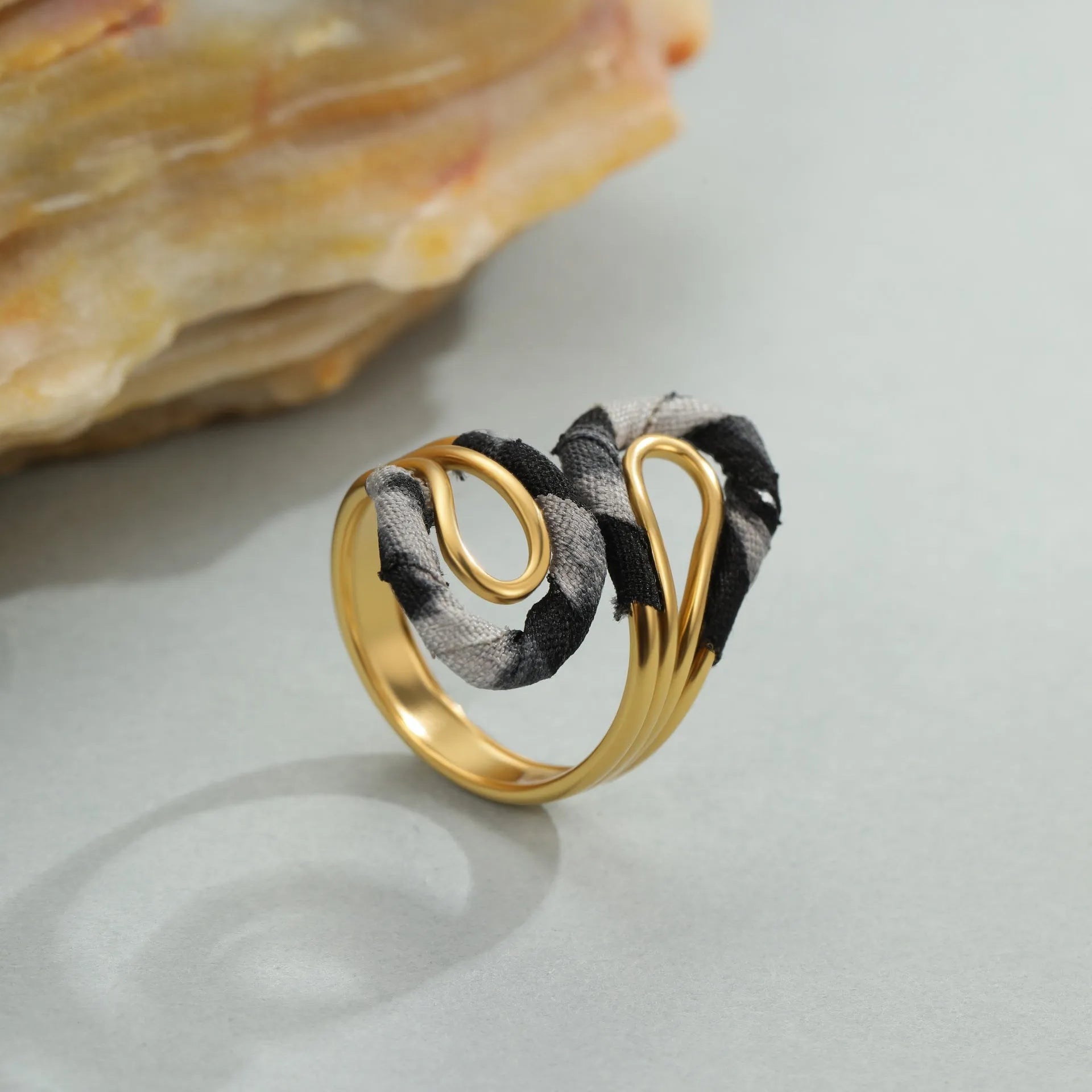 Leopard print stainless steel open mouth ring showing heart, star and geometric shapes.