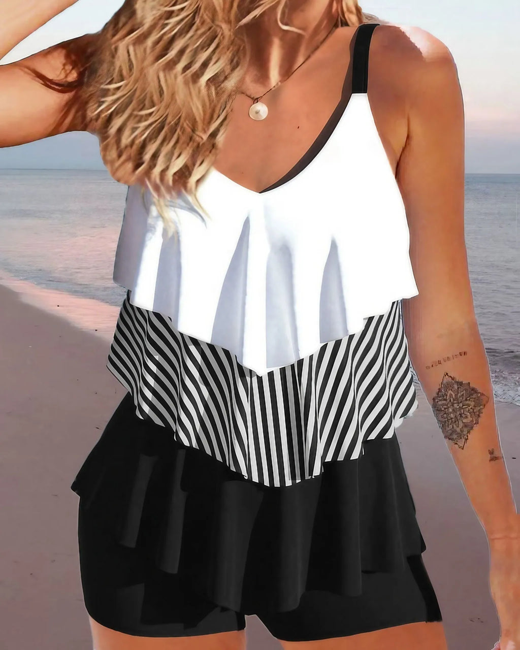 Women's sleeveless backless bikini with spaghetti straps, ruffle detail, and matching split-leg briefs.