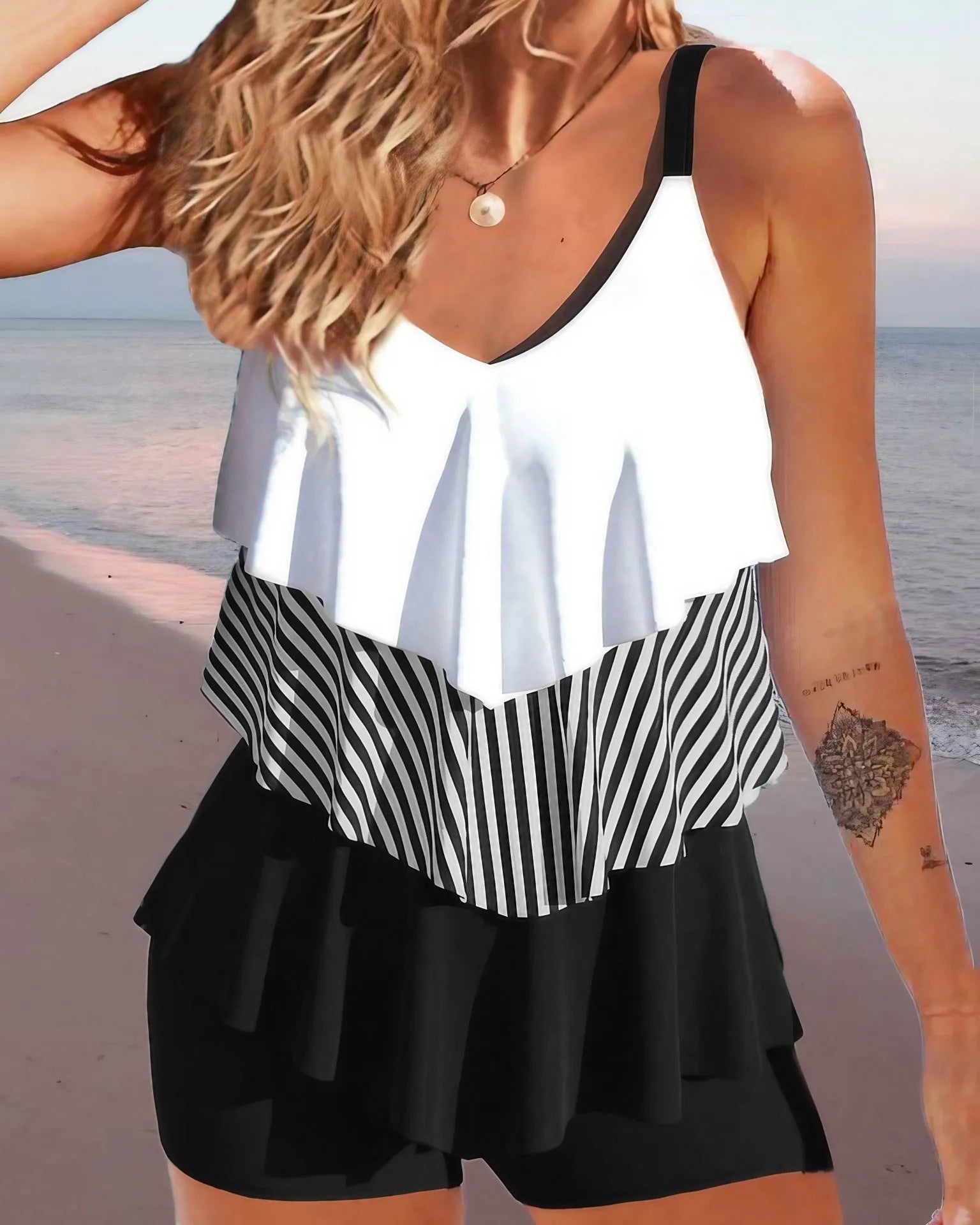 Women's sleeveless backless bikini with spaghetti straps, ruffle detail, and matching split-leg briefs.