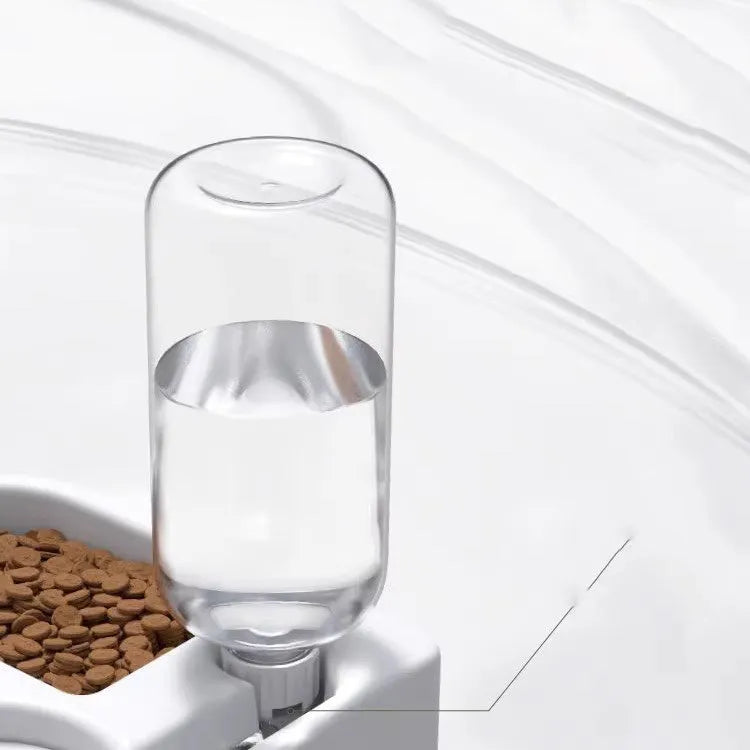 White pet water fountain for cats and dogs indoors on a kitchen floor.