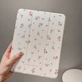 Transparent floral patterned tri-fold iPad case with magnetic stand function showing compatible tablet models