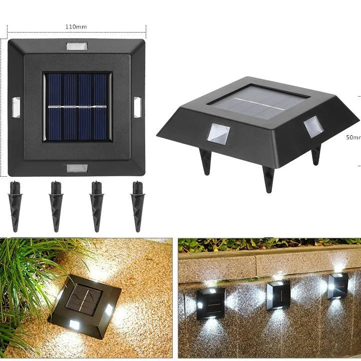 Small solar-powered black plastic outdoor wall light with LED up and down irradiation on a garden wall