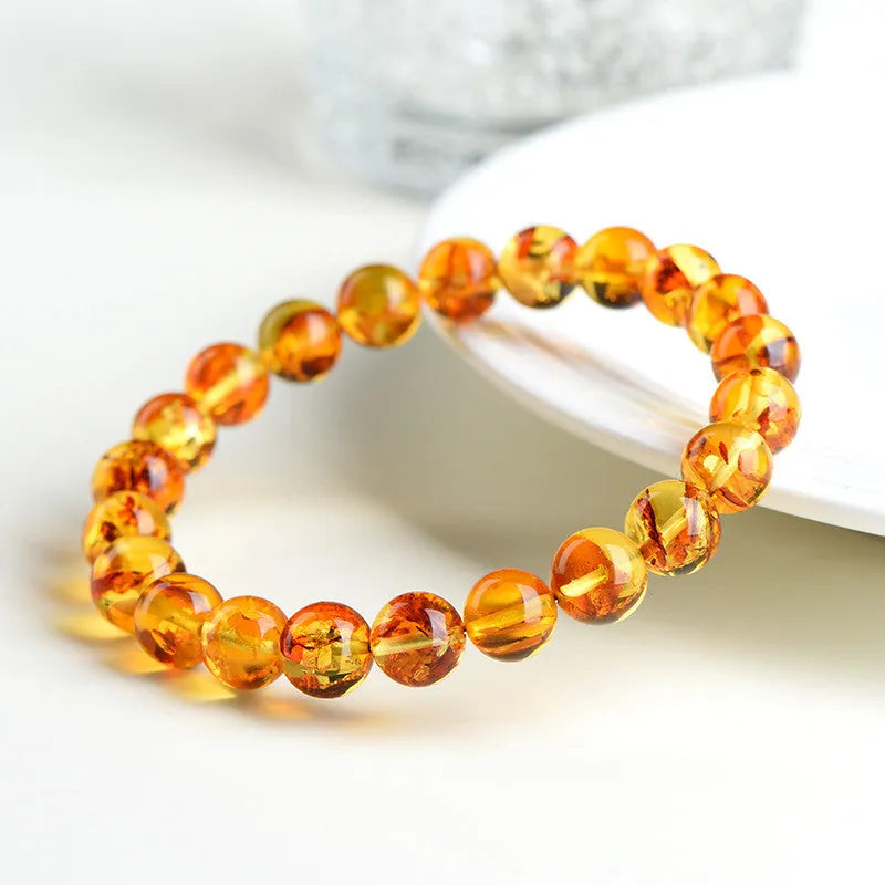 Natural yellow piebald amber bracelet with geometric beads showing distinctive flower spot patterning