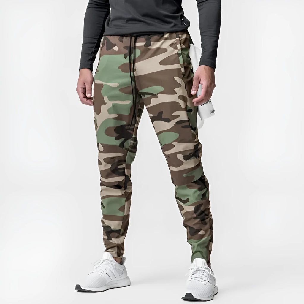 Men's grey quick-dry fitness pants with ankle ties shown in loose fit for exercise