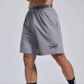 Men's loose black sports shorts with letter print and elastic waist.