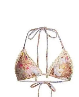 Women's creamy-white floral bikini set with halter top, briefs, and skirt