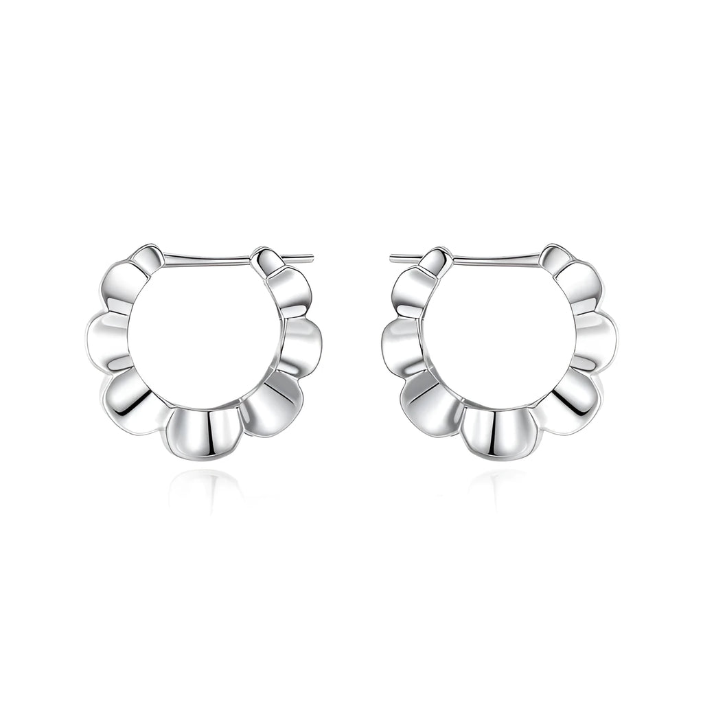 A pair of sterling silver geometric earrings with round elements on a white background.