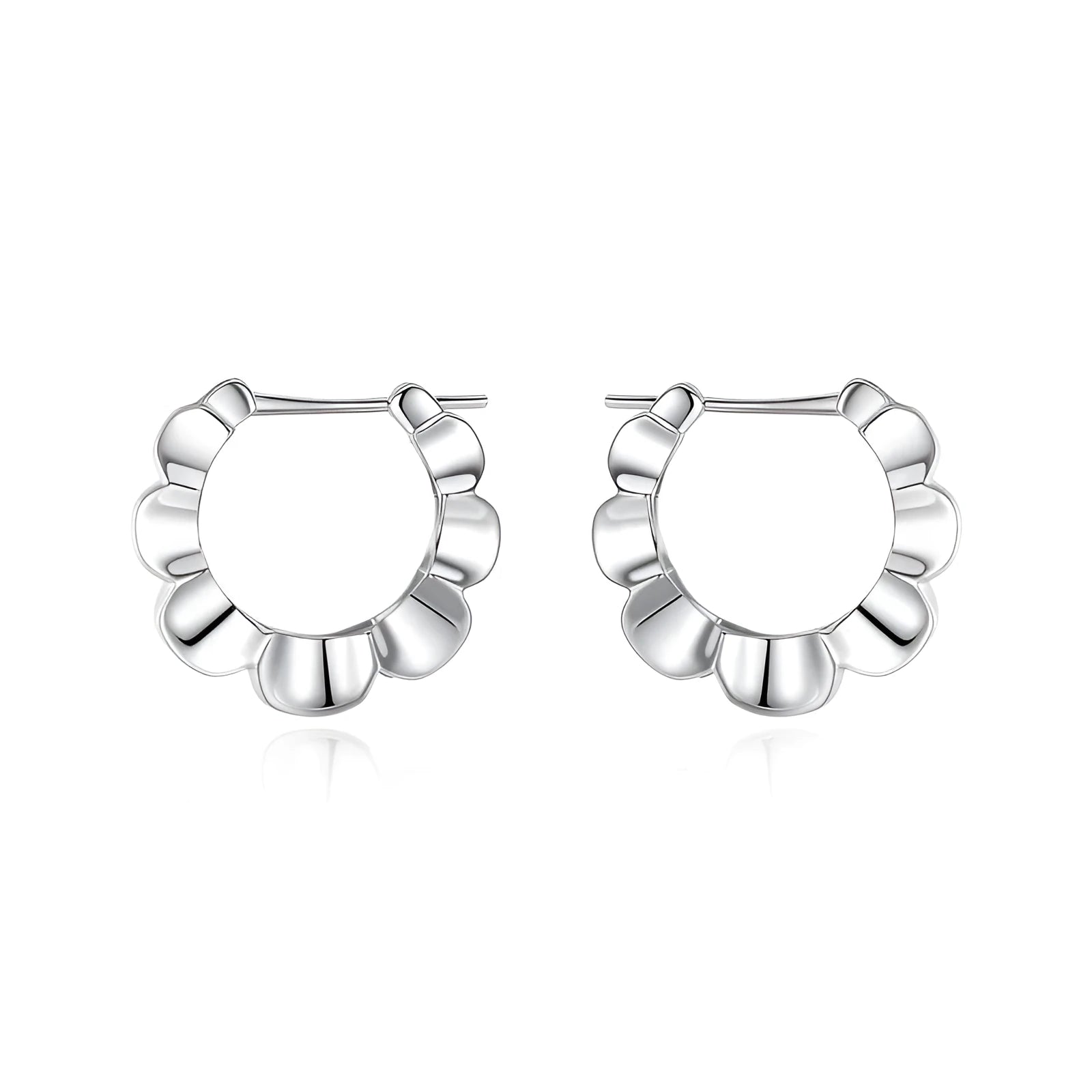 A pair of sterling silver geometric earrings with round elements on a white background.