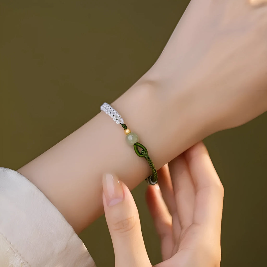 Colourful national fashion bracelet with Hetian jade and sterling silver carrying strap on a neutral background