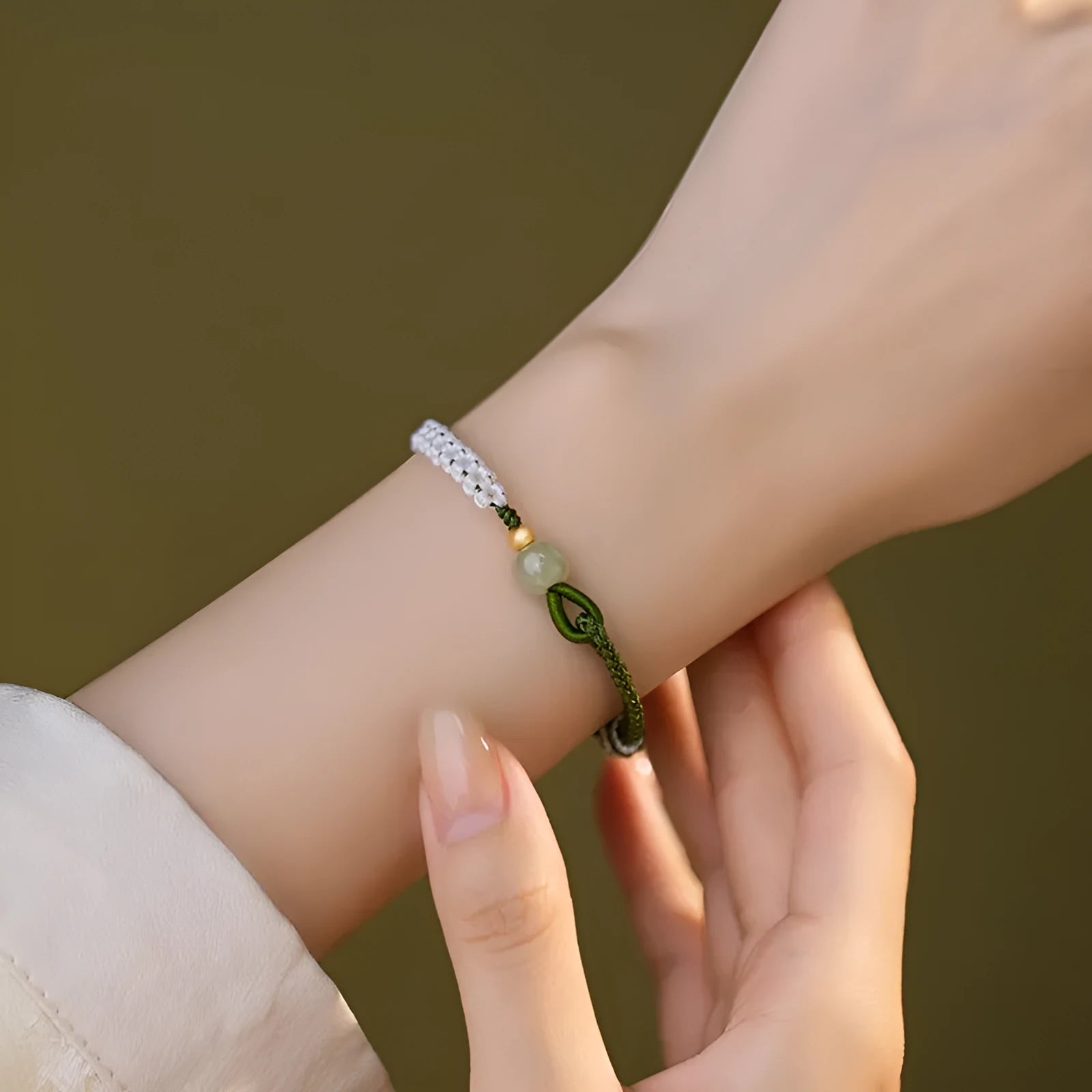 Colourful national fashion bracelet with Hetian jade and sterling silver carrying strap on a neutral background