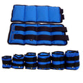Pair of Oxford cloth legging sandbags for weighted athletic training on a track.