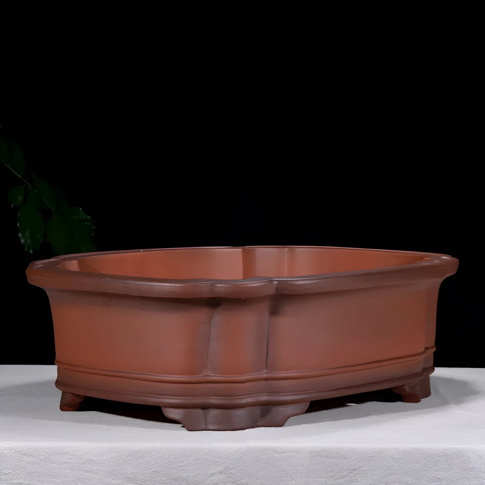 Antique-style purple clay flowerpot with Chinese decorative motifs showing tree stump, pine, cypress, pomegranate, golden marble, antique jade belt, and crabapple designs