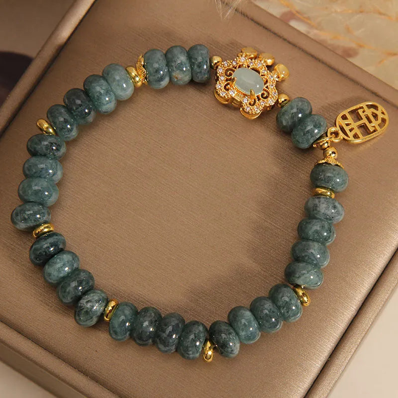 Natural emerald jade bracelet for women with abacus beads and a safety lock clasp on a white background.