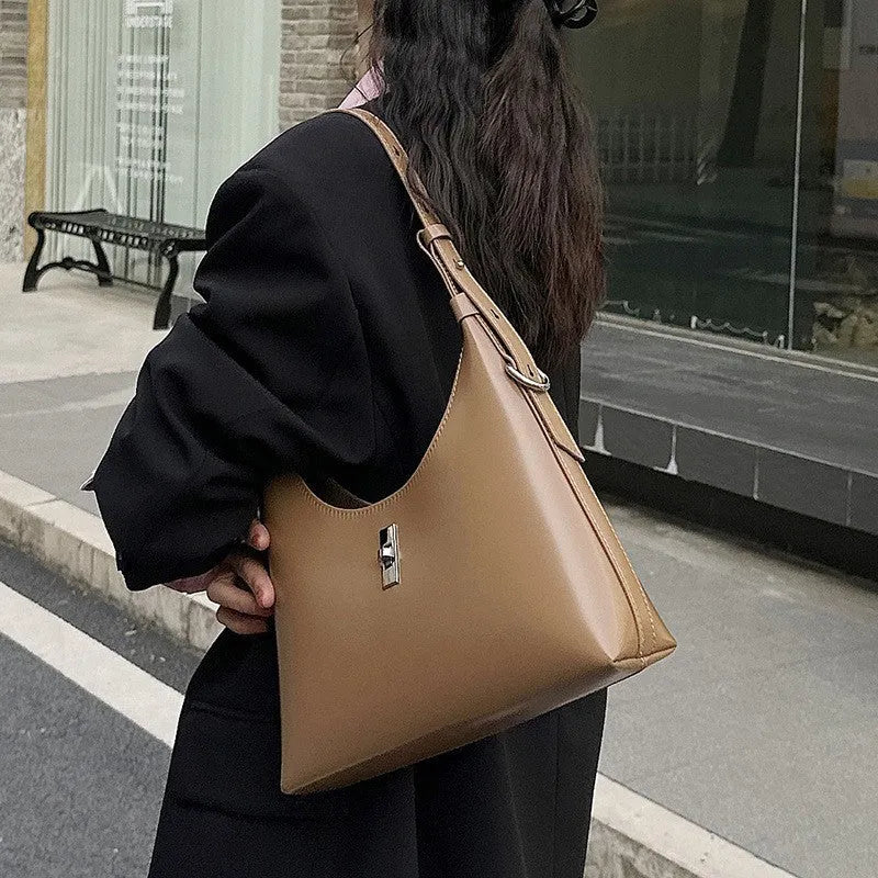 Soft brown genuine leather dumpling-shaped crossbody bag with a front sandwich pocket.