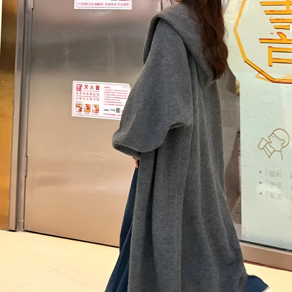 Long brown hooded knitted cardigan for women in a loose, below-the-knee fit.