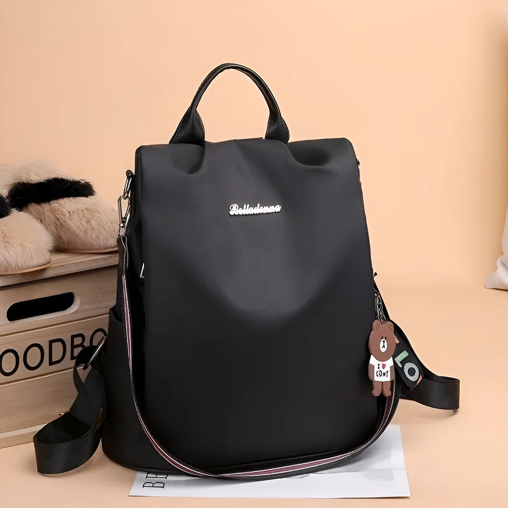 Women's large capacity black backpack with Oxford fabric lining, laptop sleeve, and trendy stitched seams and colour blocking