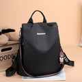Women's large capacity black backpack with Oxford fabric lining, laptop sleeve, and trendy stitched seams and colour blocking