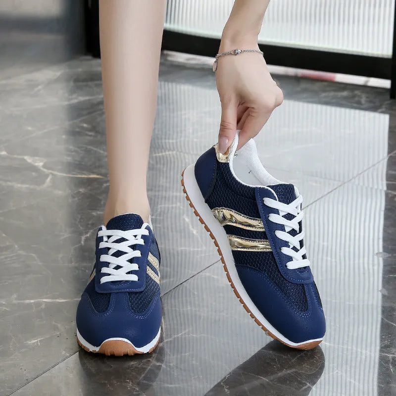 Blue women's casual tennis shoes with cross straps and white rubber sole