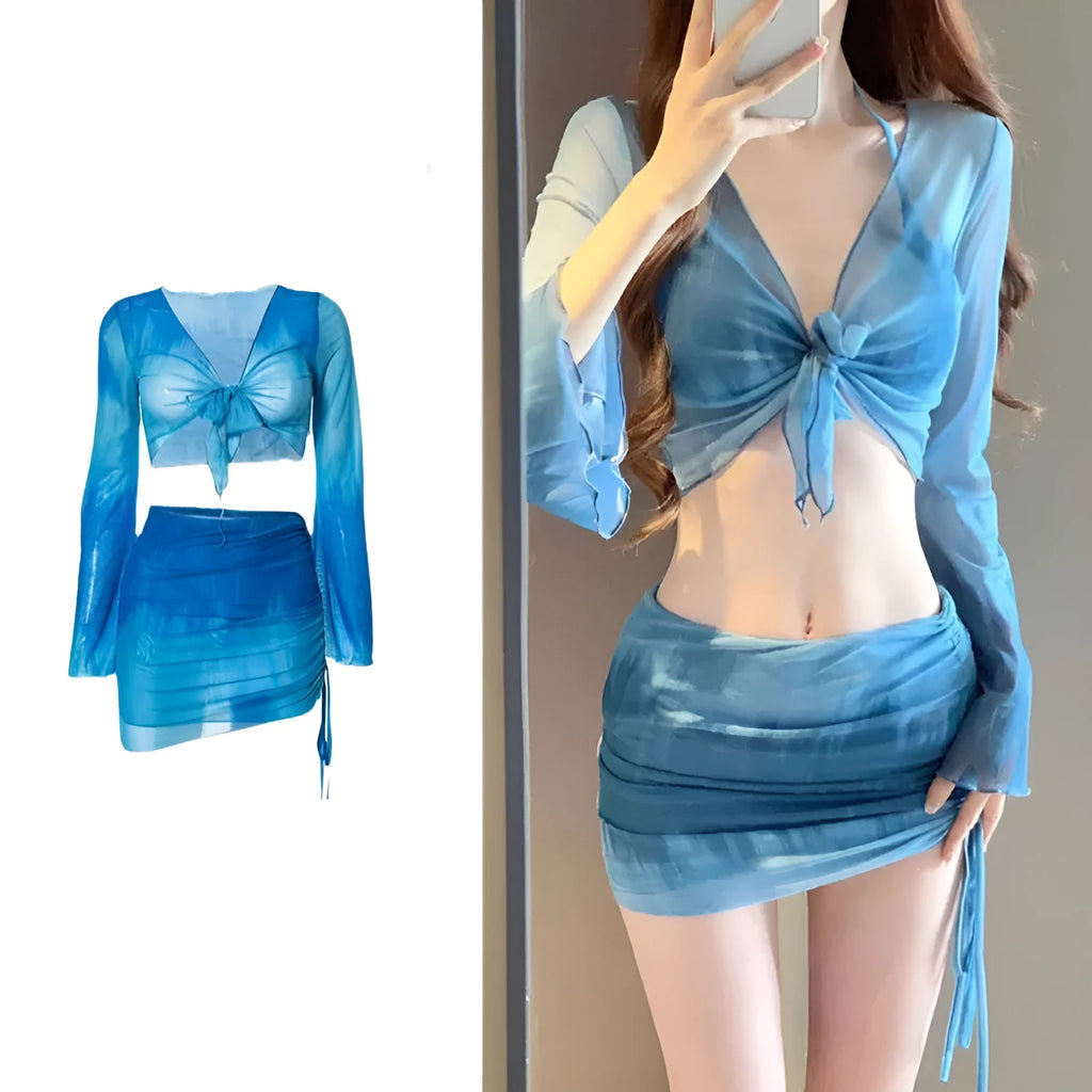 Women's blue high-waist bikini set with shirt, bra, underwear, and skirt laid flat.