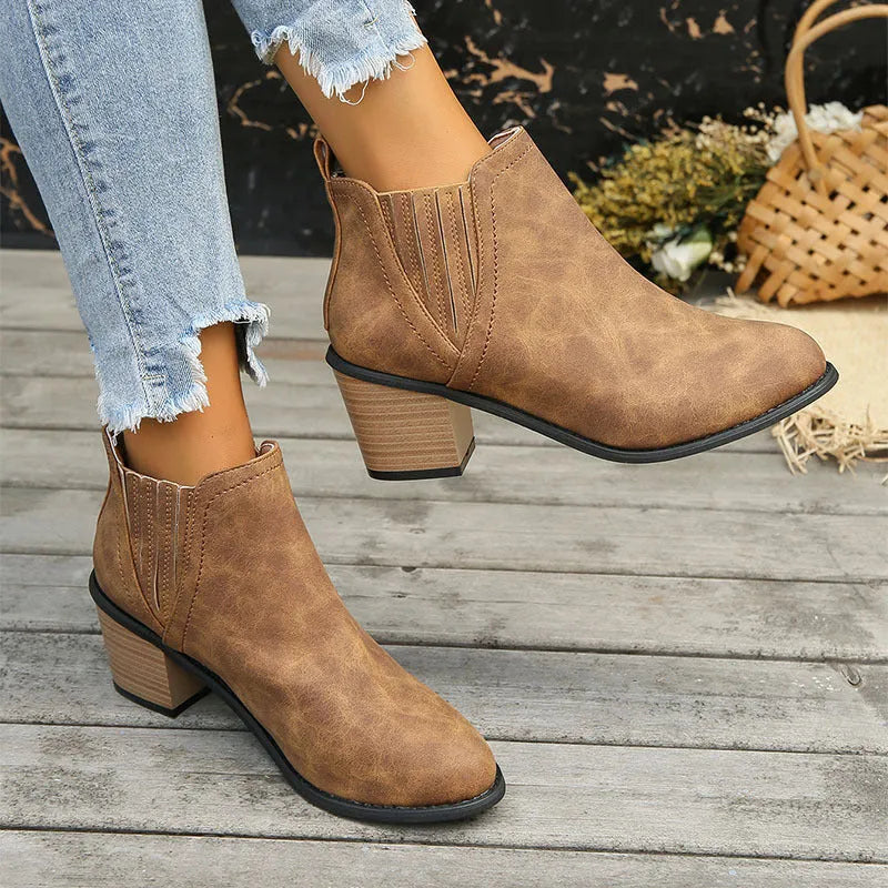 Women's black ankle boots with pointed toe, thick square heel and slip-on design