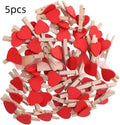 Five handmade solid wood heart-shaped clips in red, pink, white, yellow colours on a wood surface.