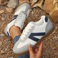 Women's blue flat German training hiking shoes with rubber sole and artificial PU upper, low-top lace-up style on neutral background