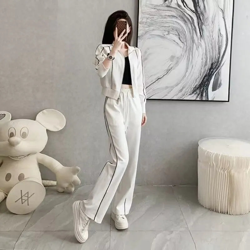 Women's two-piece set with short zipper sweater and wide leg trousers in solid colour polyester, black and white options available