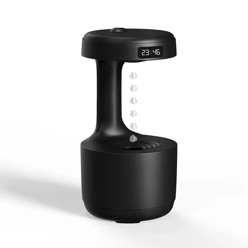 White anti-gravity air humidifier with ultrasonic mist levitating water drops on a desk